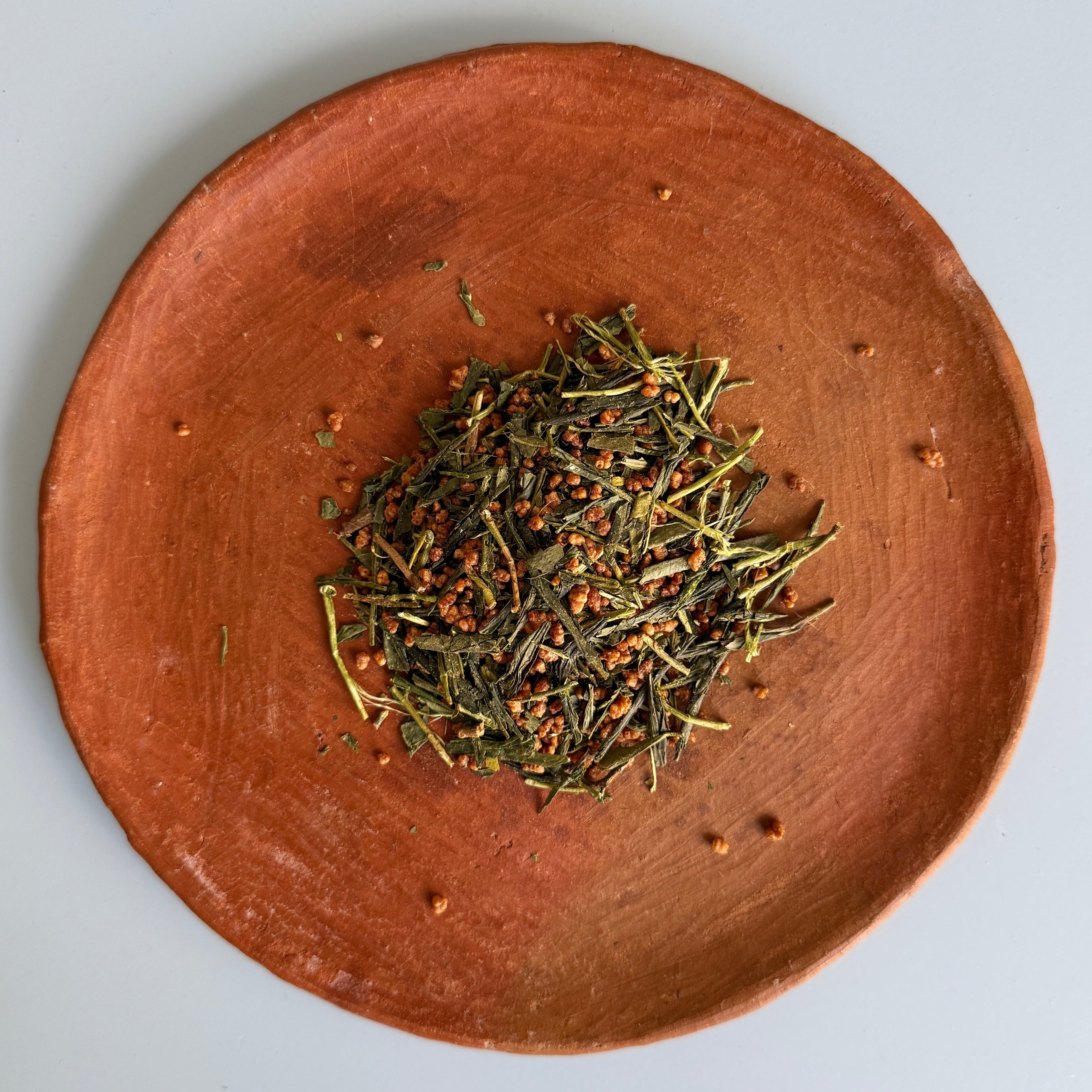Ceramic plate with genmaicha green tea blended with roasted rice from Teanuki. 