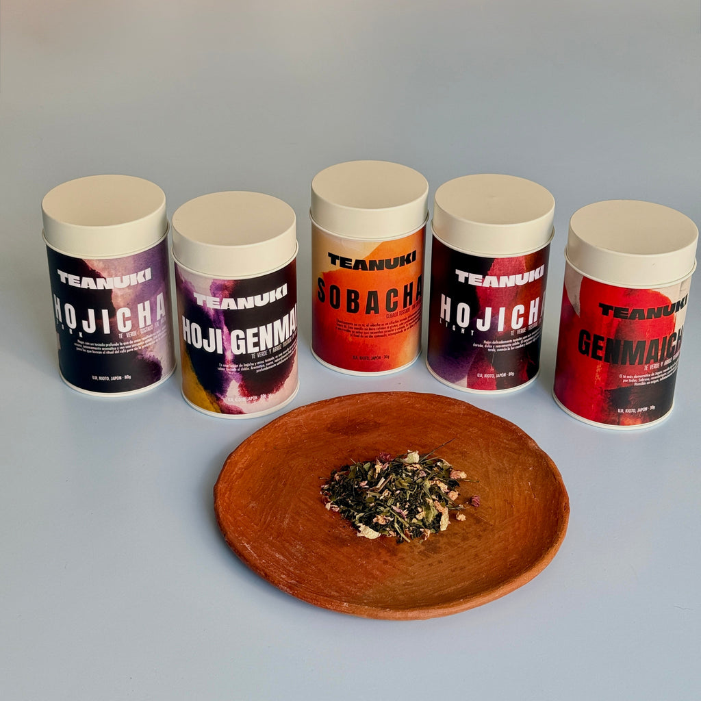 Set of five 'TEANUKI' white tea tins with a clay plate containing some of the loose leaf on display. All are roasted or tasted japanese teas. 