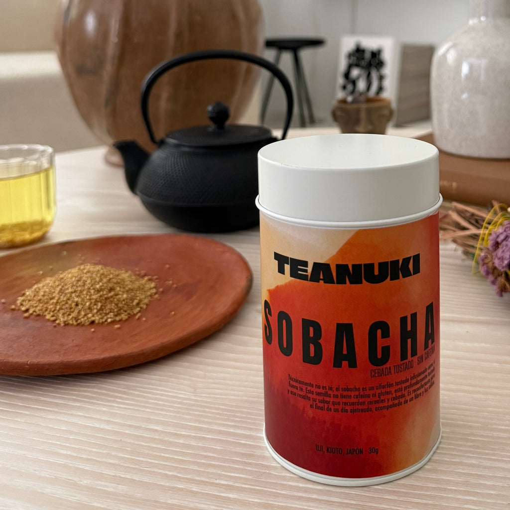 Tea canister labeled 'Teahuki Sobacha' on a table with tea-making items in the background
