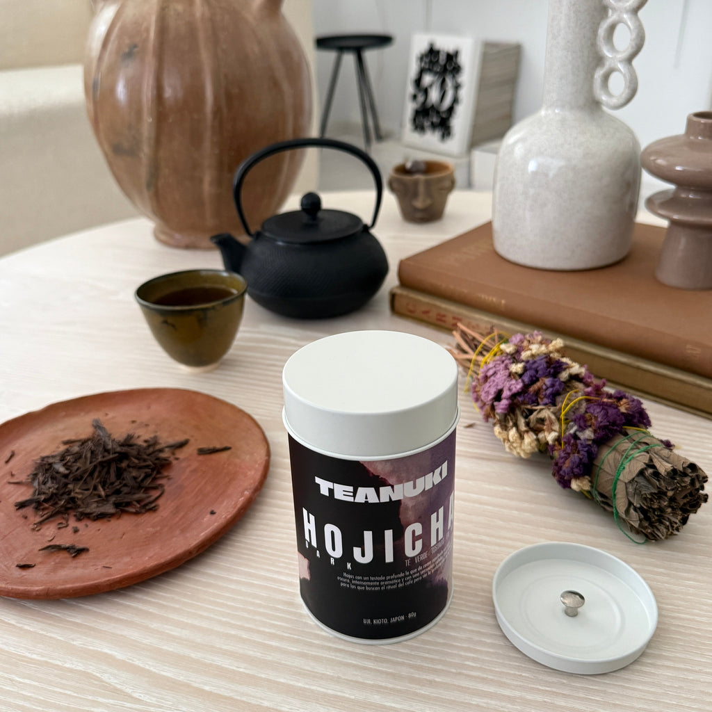 Teanuki Dark Roast Hojicha Tea packaging on a wooden surface with decorative items